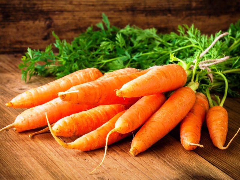 36483107 - fresh carrots bunch on rustic wooden background